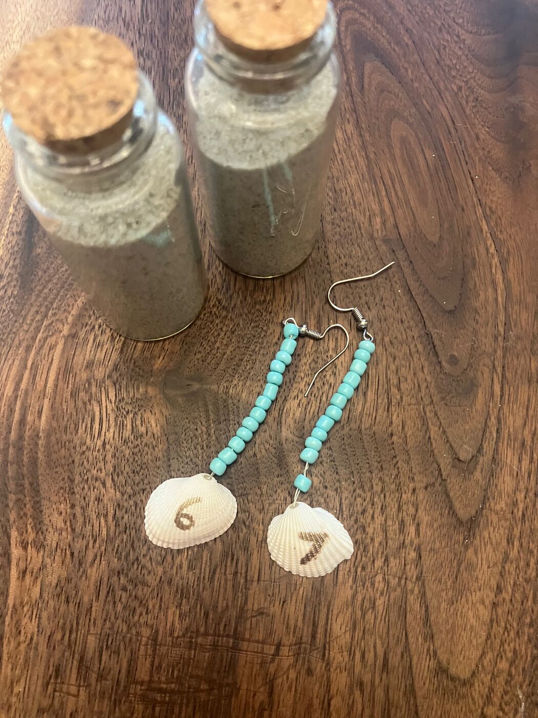 Turquoise beaded earrings finished with two little cowrie shells
