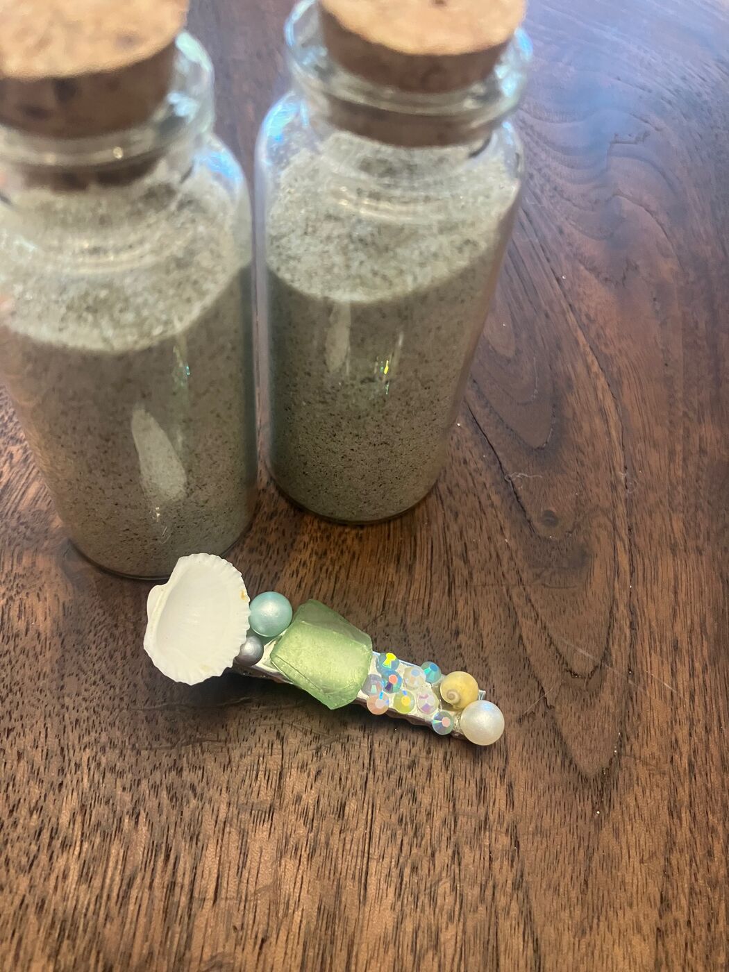 A hair clip with beads and a real shell