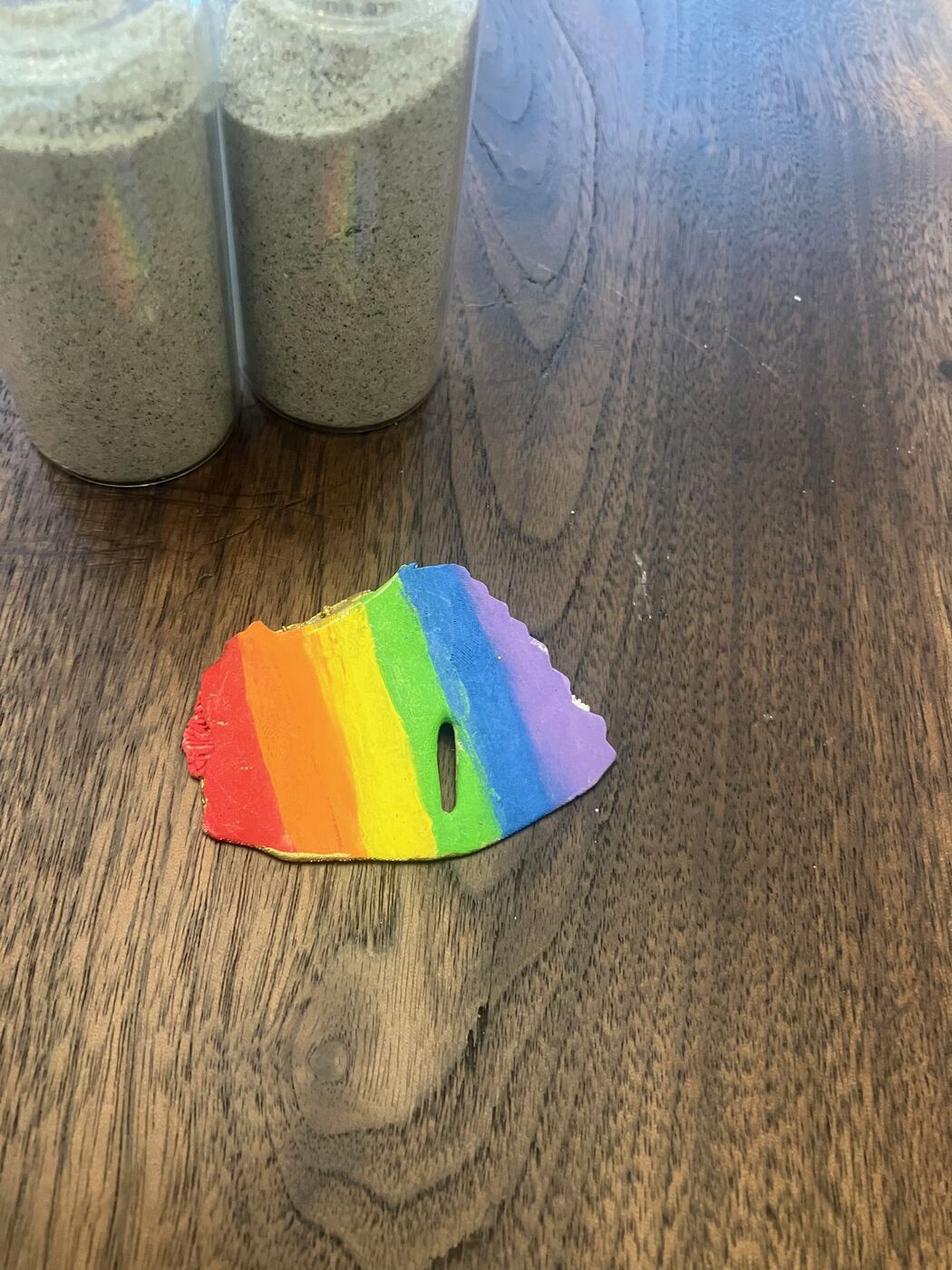 Shell painted with bright rainbow stripes